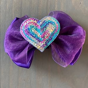 Sequin heart on purple bow. Brand new.